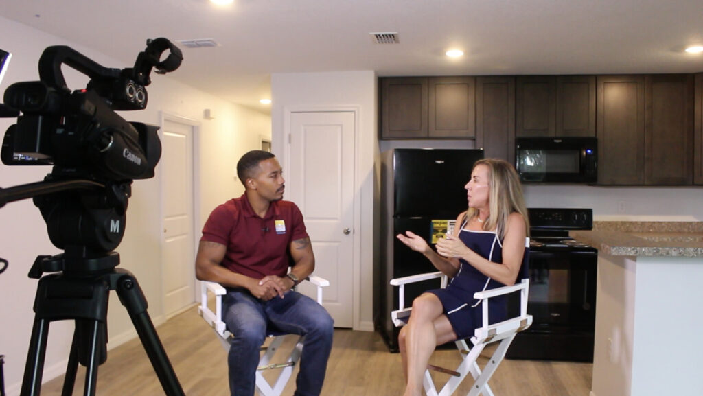 Behind the Scenes Photo of Penny Seater and Dr Ethan Johnson Mid Conversation